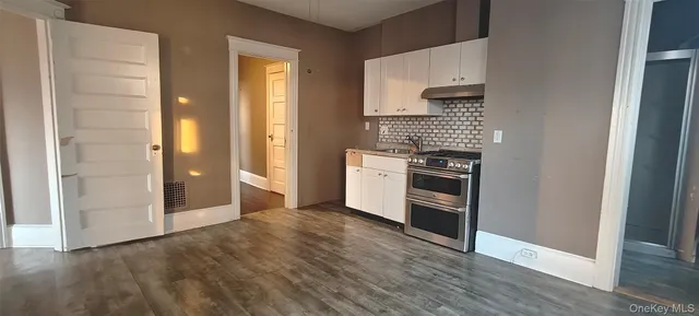 a kitchen with stainless steel appliances a refrigerator and a stove top oven