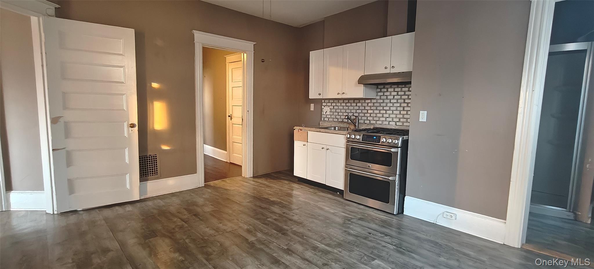 a kitchen with stainless steel appliances a refrigerator and a stove top oven