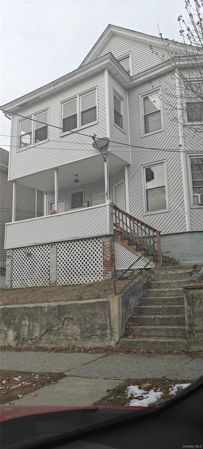 27 Franklin Street, Unit 1F Poughkeepsie, NY 12601 - Photo 7 of 7 View of front of house with covered porch and stairway