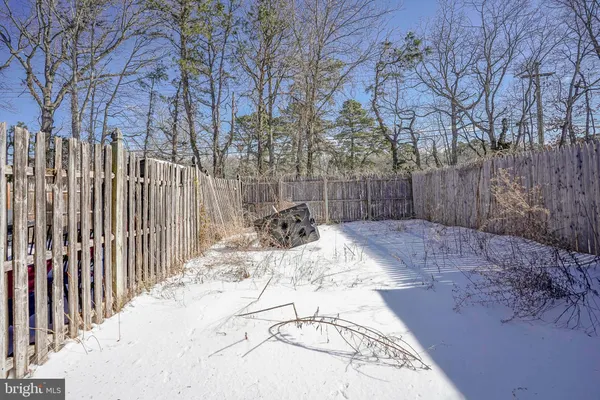 a view of a backyard with wooden fence