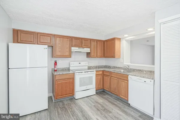 a kitchen with a white cabinets and white appliances