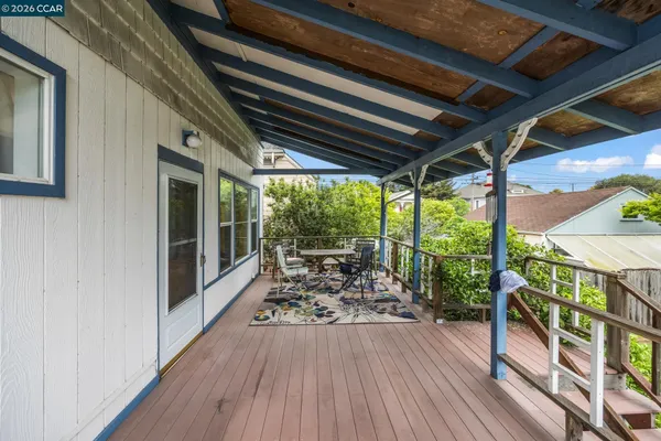 a view of a porch with wooden floor