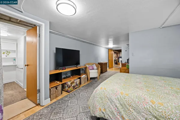 a bedroom with a bed and a flat screen tv