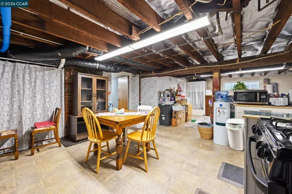 a dining room with furniture and kitchen view