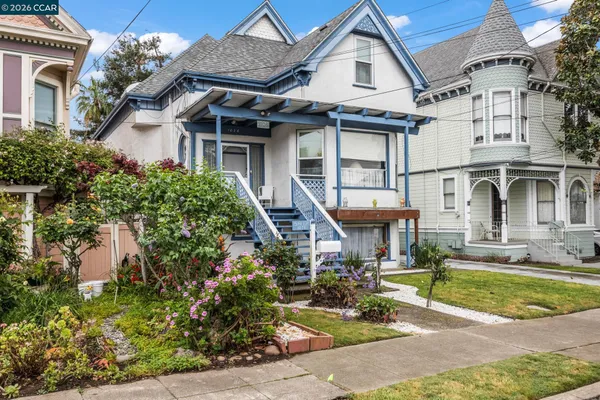 a front view of a house with garden and porch