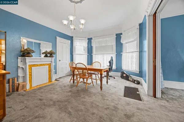 a view of a dining room with furniture and a chandelier