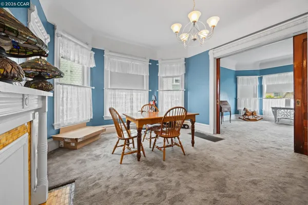 a dining room with furniture and a chandelier