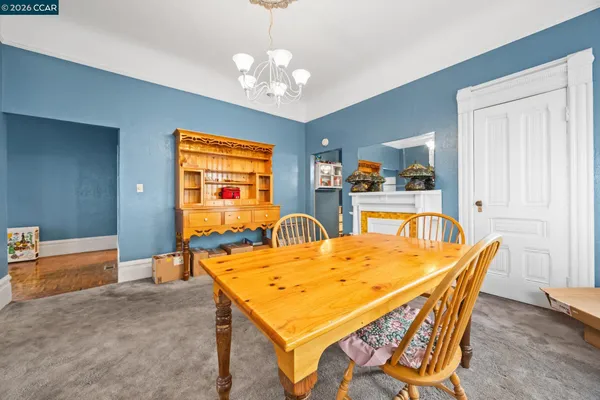 a dining room with a table chairs and a chandelier