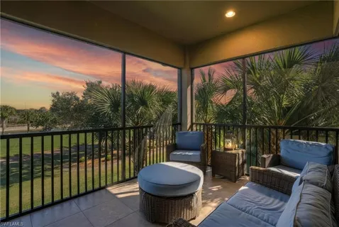 a view of a porch with furniture and wooden floor
