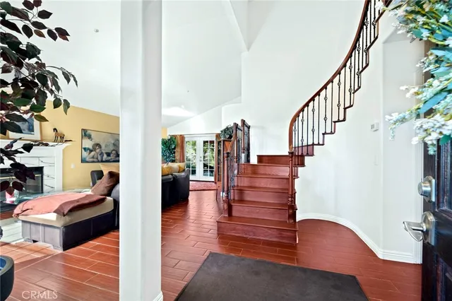 a living room with patio furniture and a rug
