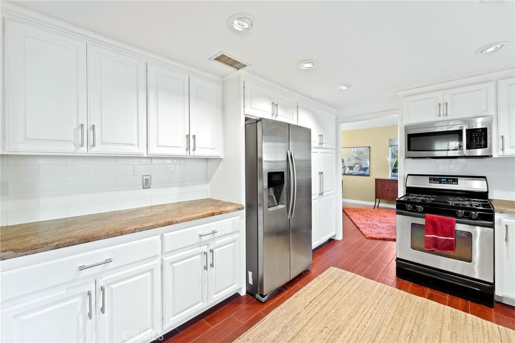 334 Rainbow Crest Road Fallbrook, CA 92028 - Photo 24 of 42 a kitchen with stainless steel appliances granite countertop a refrigerator stove and white cabinets