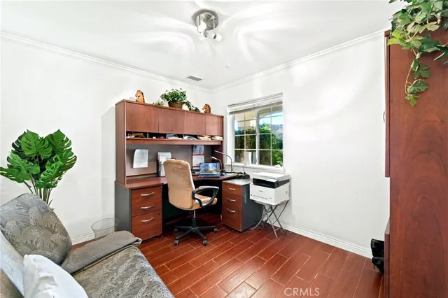 a spacious bedroom with a bed flat screen tv and a large window