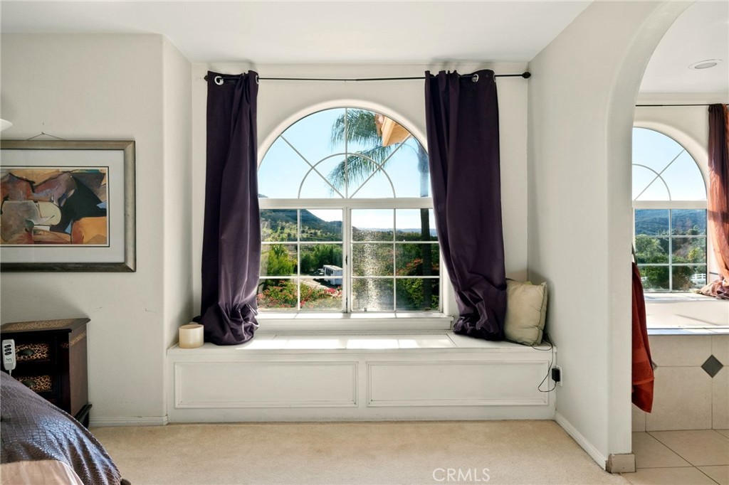 334 Rainbow Crest Road Fallbrook, CA 92028 - Photo 33 of 42 a living room with large stone fireplace and a large window