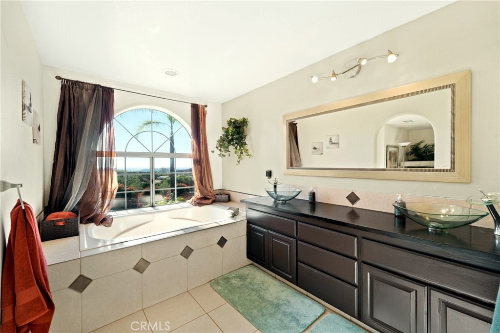 334 Rainbow Crest Road Fallbrook, CA 92028 - Photo 34 of 42 a bathroom with a granite countertop sink mirror and a window