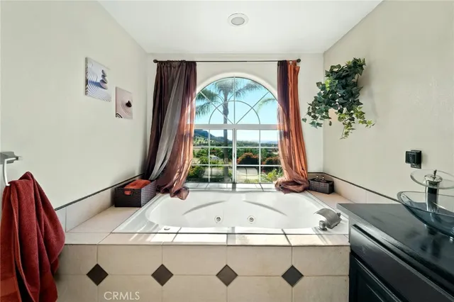 a bathroom with a granite countertop sink a toilet a mirror and shower