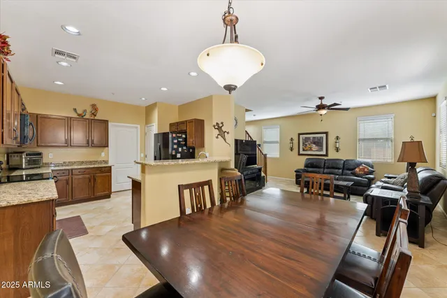 a living room with furniture a dining table and kitchen view