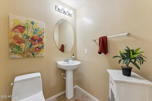 a bathroom with a sink a mirror and a toilet
