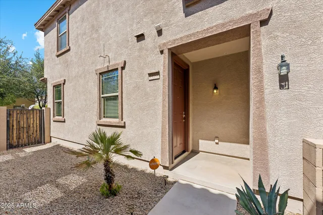 a view of a front door and small yard