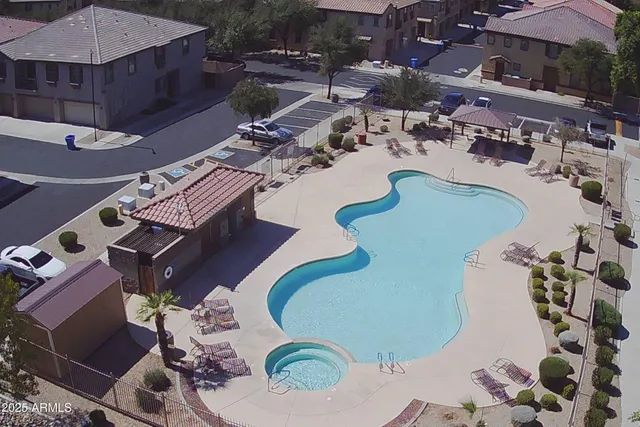 a view of a swimming pool with outdoor seating