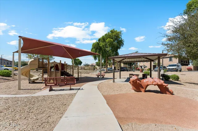 a view of a patio with a table and chairs under an umbrella