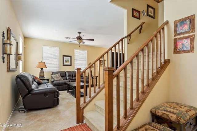 a living room with wooden floor and stairs