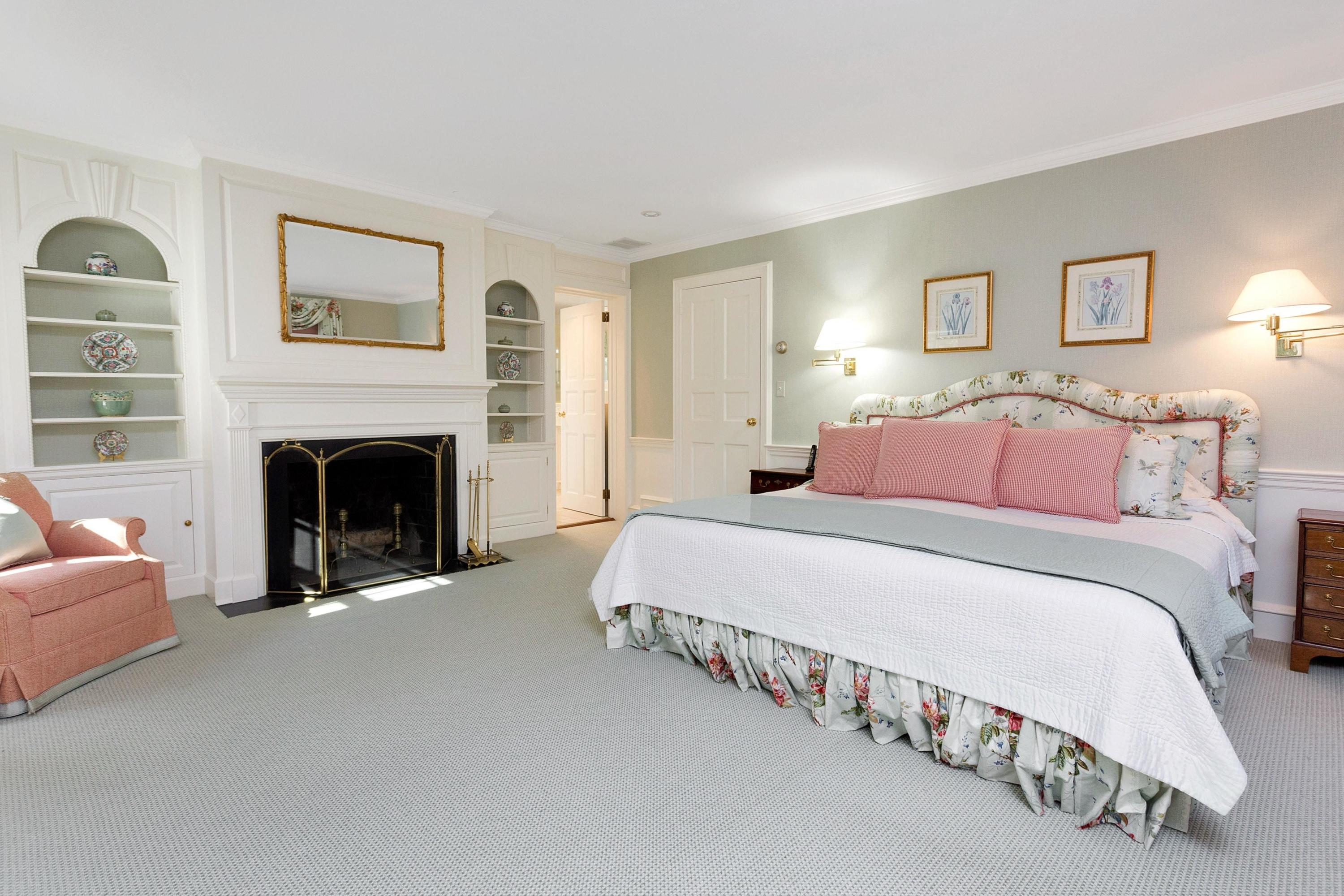 87 Ridge Acres Road Darien, CT 06820 - Photo 23 of 36 a spacious bedroom with a bed and a fireplace