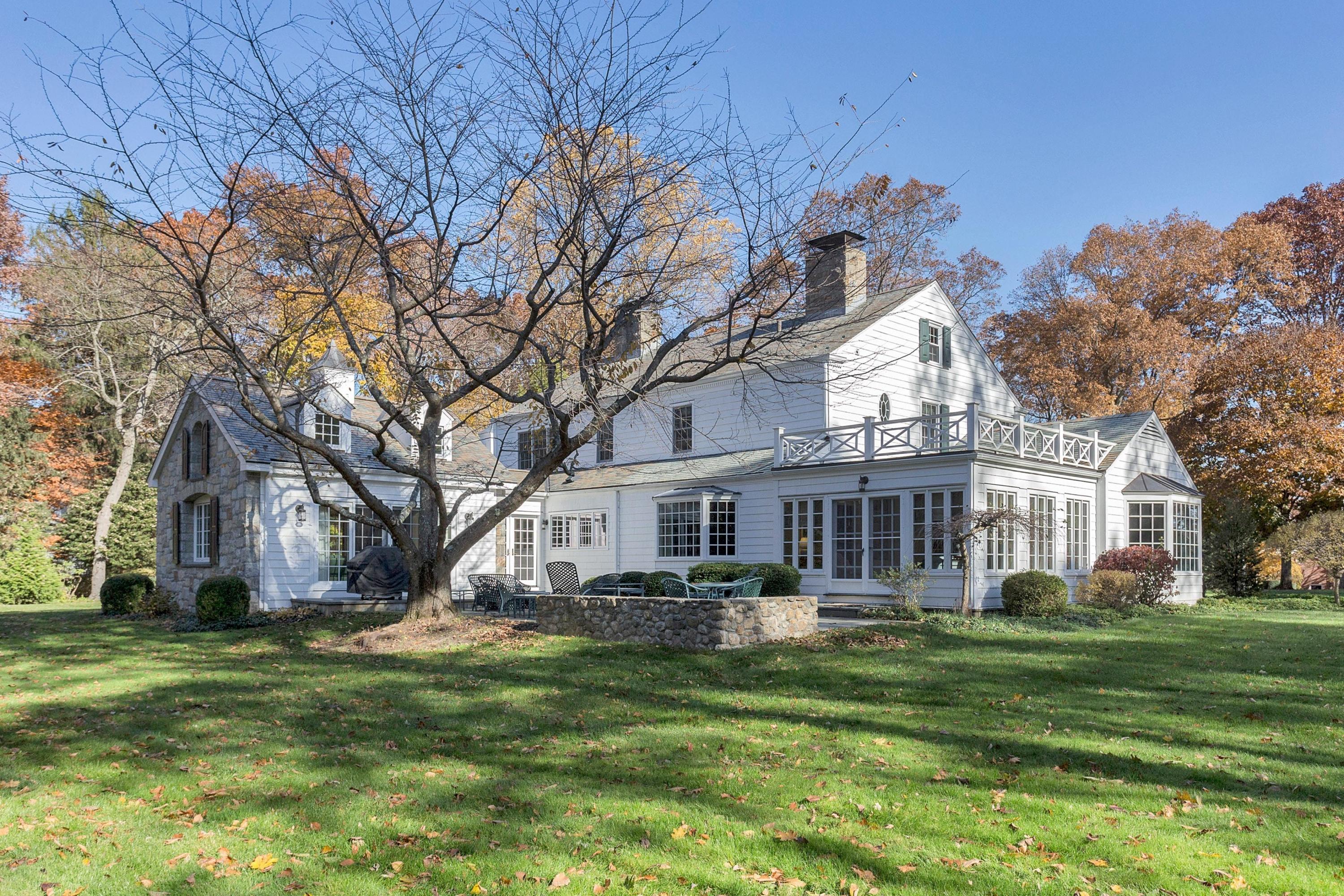 87 Ridge Acres Road Darien, CT 06820 - Photo 33 of 36 a front view of a house with a garden and trees