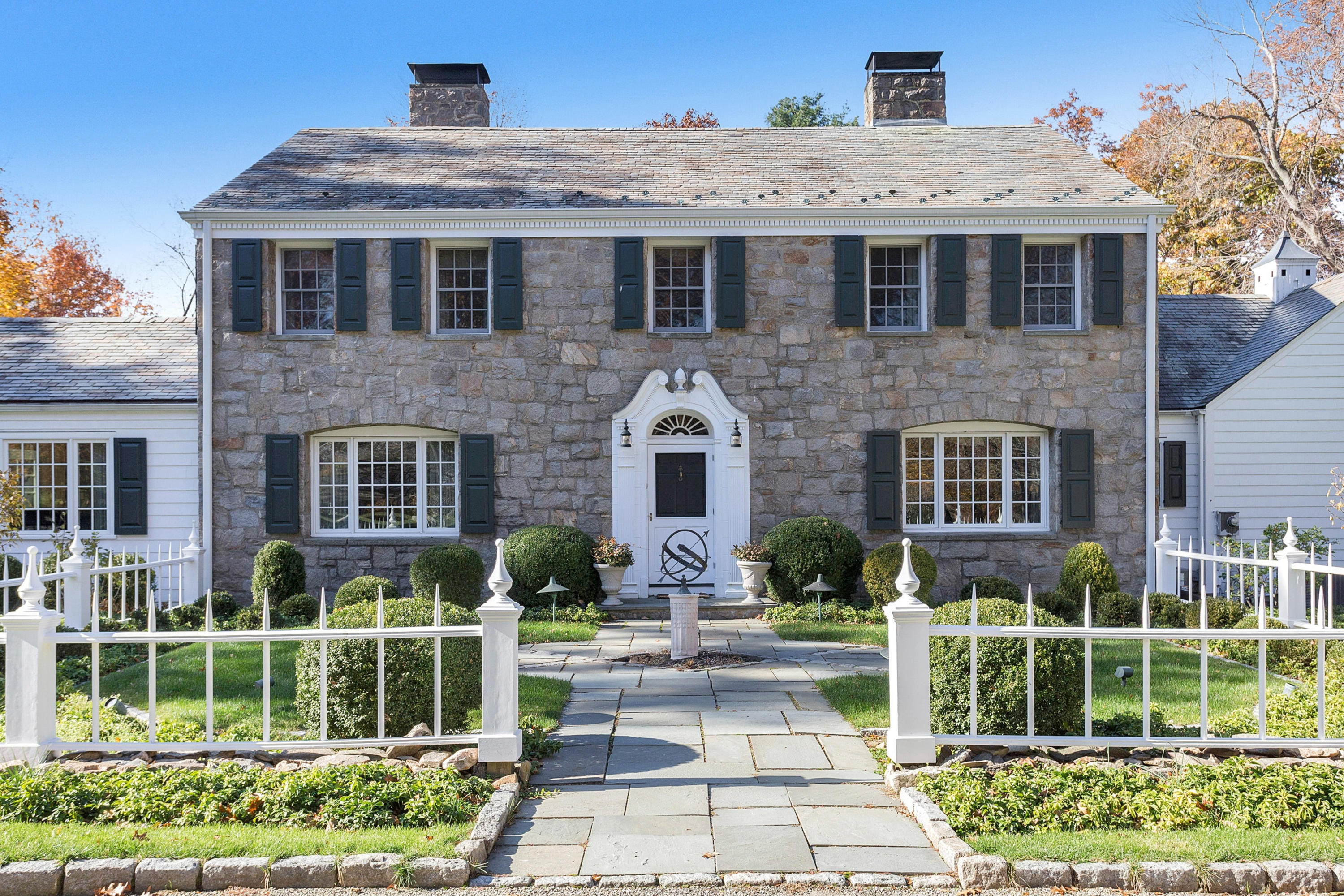 87 Ridge Acres Road Darien, CT 06820 - Photo 5 of 36 a front view of a house with plants and entryway