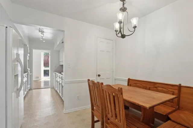 a view of a dining room with furniture wooden floor and chandelier