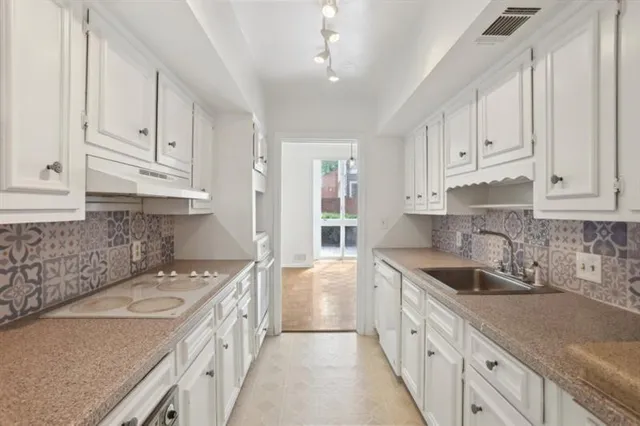 a kitchen that has a sink and a stove