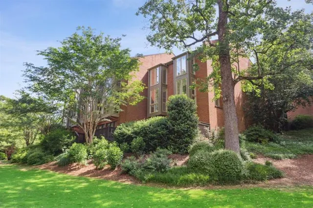 a view of a brick wall with a building in the background