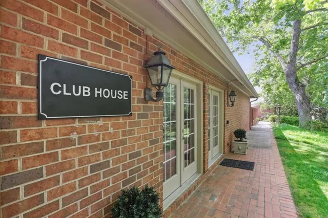 a view of a patio with table and chairs potted plants and a large tree