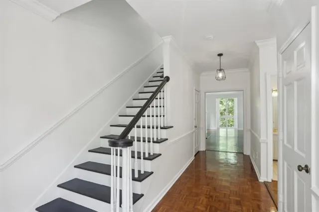 a view of entryway and hall with wooden floor