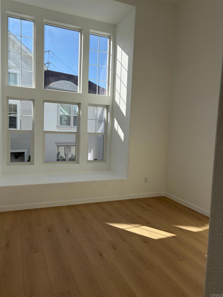 815 Harbor Cliff Way, Unit 239 Oceanside, CA 92054 - Photo 4 of 11 a view of a kitchen with wooden floor and cabinets