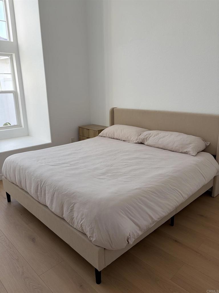 815 Harbor Cliff Way, Unit 239 Oceanside, CA 92054 - Photo 6 of 11 a bedroom with a bed and a window