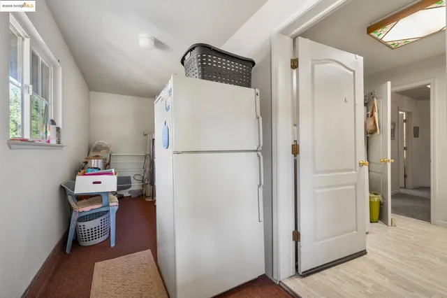 a kitchen with a refrigerator and a stove