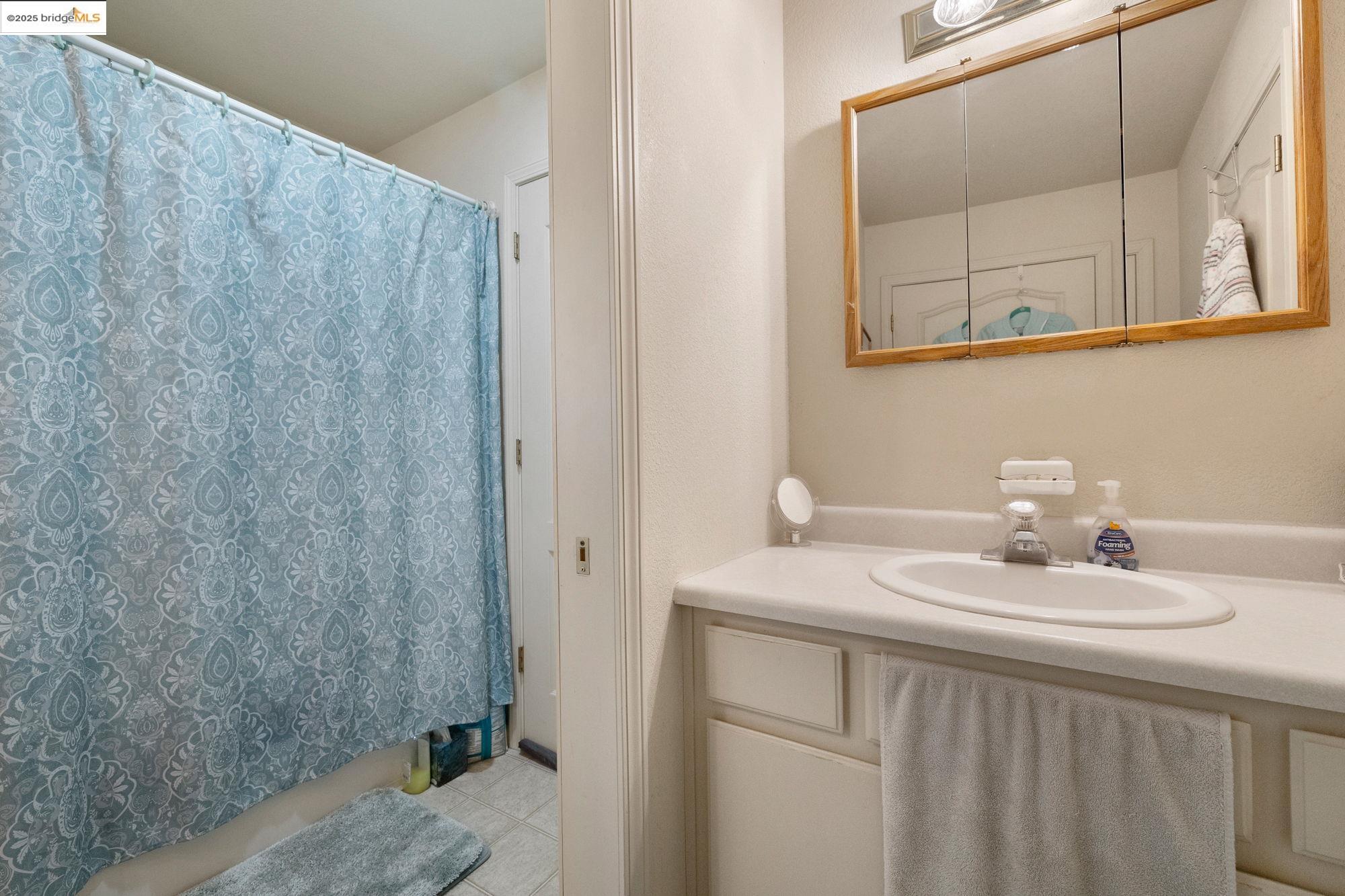 16641 Buckhorn Mountain Road Sonora, CA 95370 - Photo 15 of 44 Full bath with a shower with shower curtain, vanity, and light tile patterned flooring