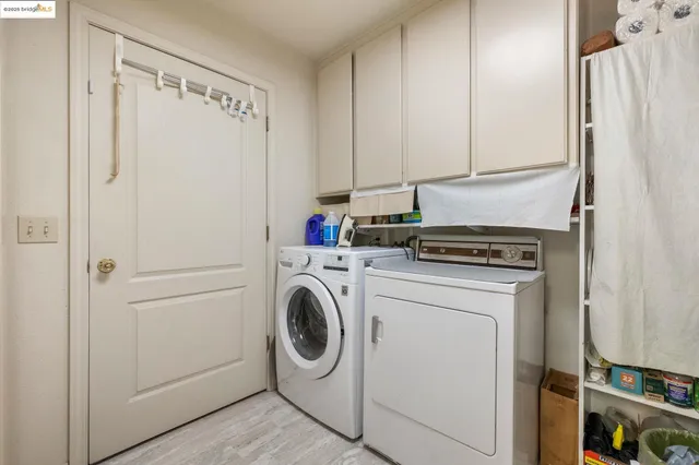 a view of a storage and utility room with washer and dryer