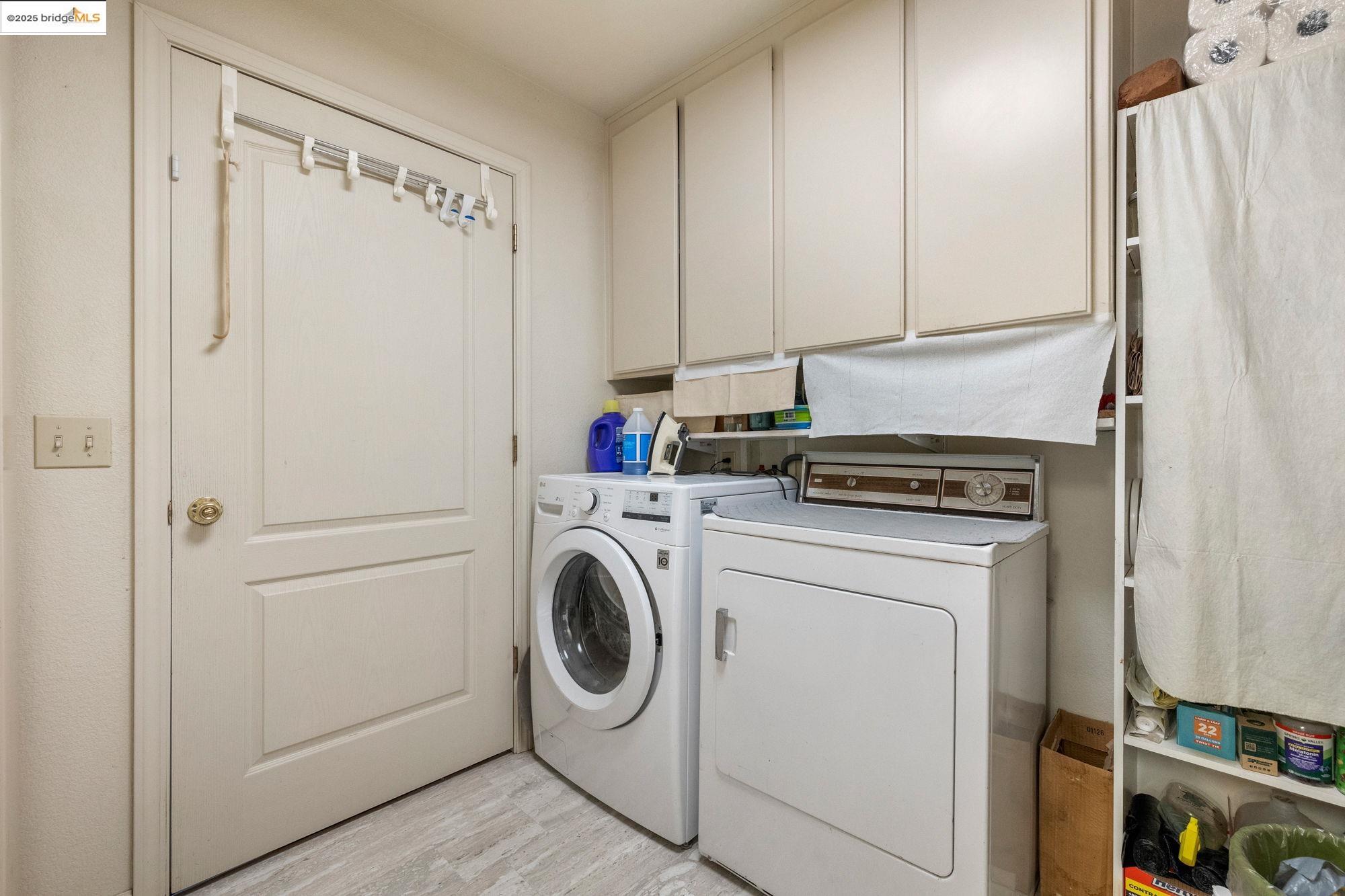 16641 Buckhorn Mountain Road Sonora, CA 95370 - Photo 19 of 44 Laundry area featuring cabinet space, separate washer and dryer, and light wood-type flooring