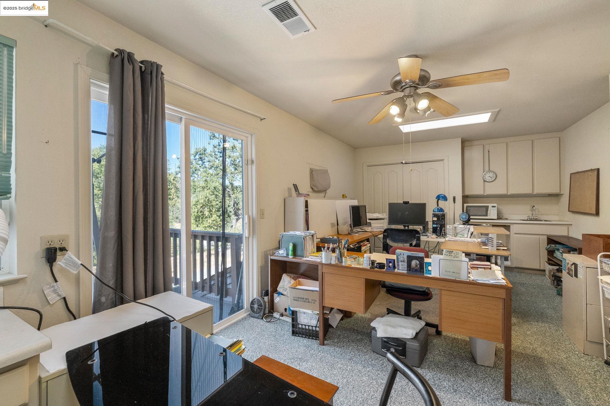 16641 Buckhorn Mountain Road Sonora, CA 95370 - Photo 26 of 44 Carpeted office space featuring a ceiling fan and a skylight
