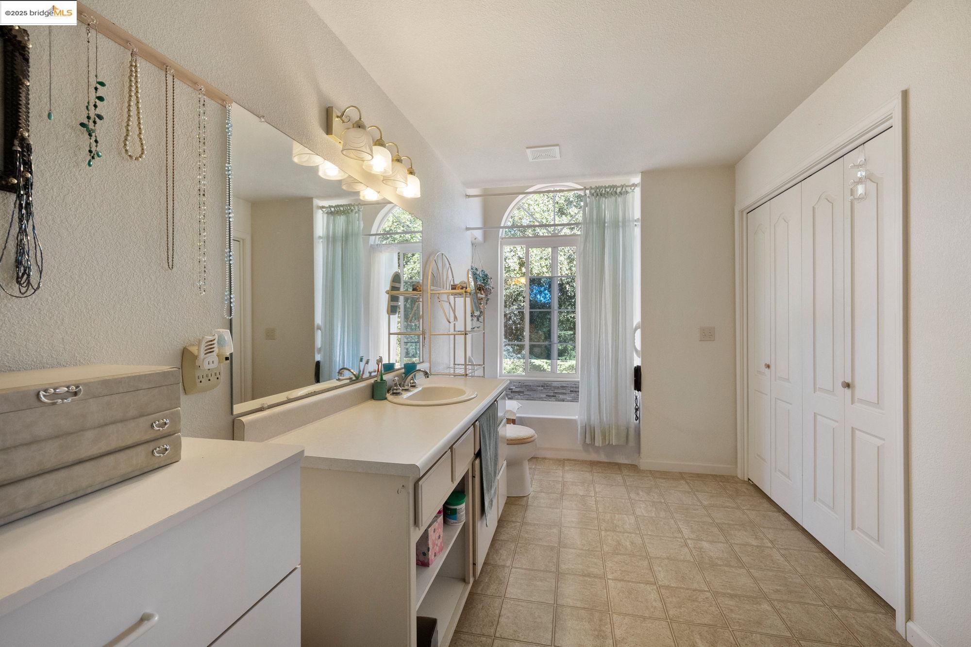 16641 Buckhorn Mountain Road Sonora, CA 95370 - Photo 27 of 44 Full bathroom featuring vanity, a bath, light flooring, and a closet