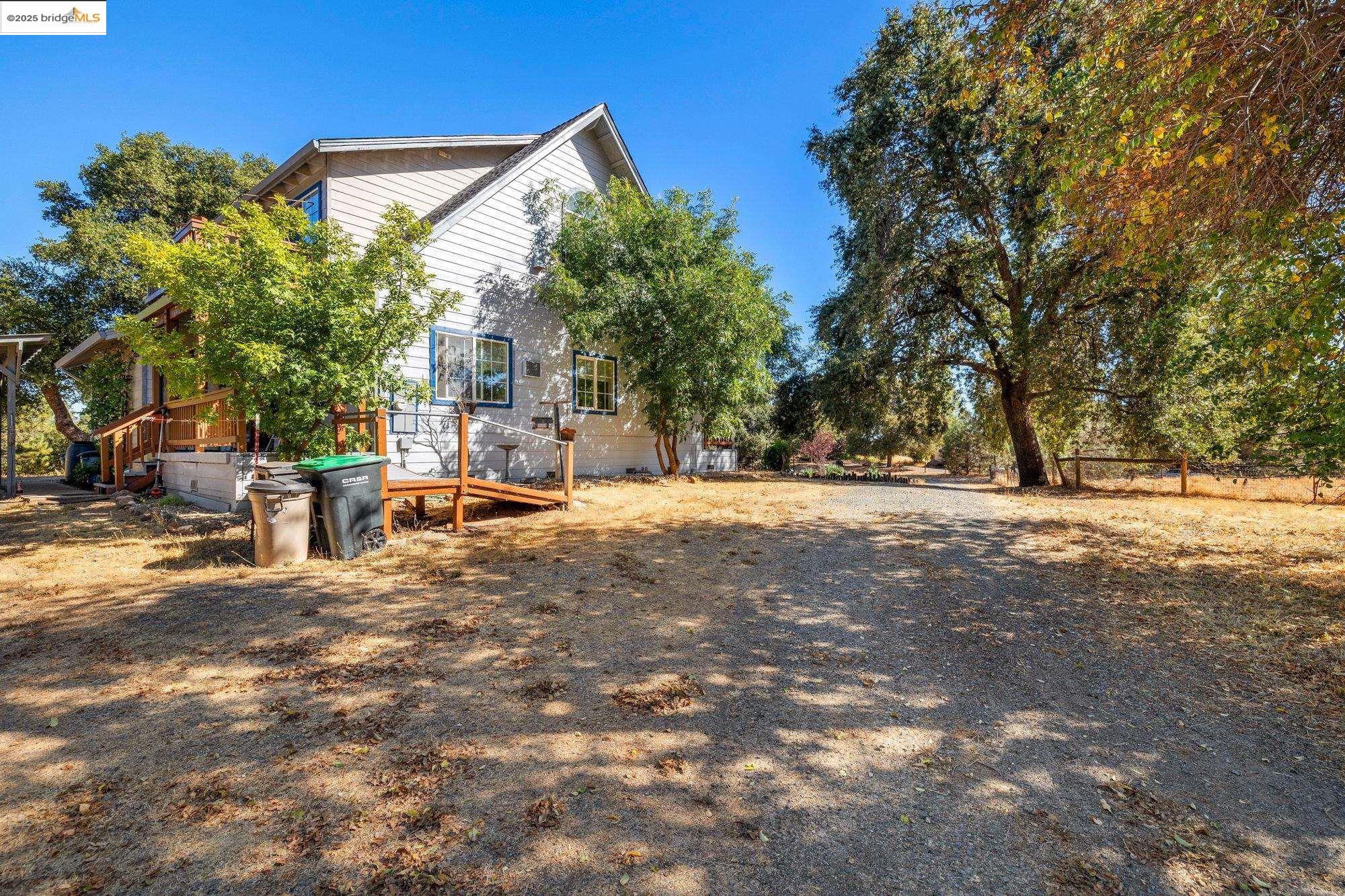 16641 Buckhorn Mountain Road Sonora, CA 95370 - Photo 32 of 44 View of property exterior featuring a wooden deck