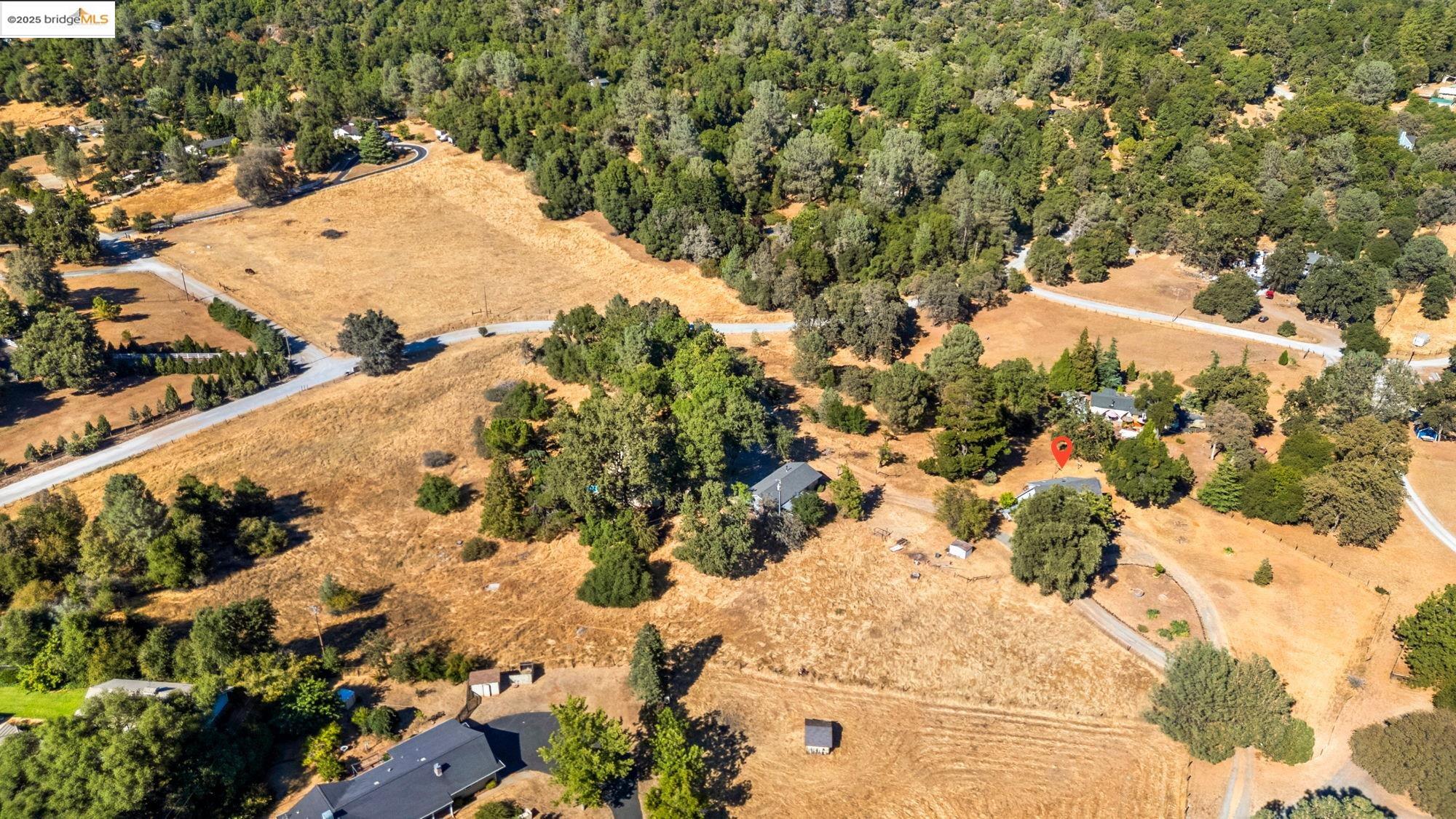 16641 Buckhorn Mountain Road Sonora, CA 95370 - Photo 41 of 44 Aerial view of property and surrounding area featuring a heavily wooded area