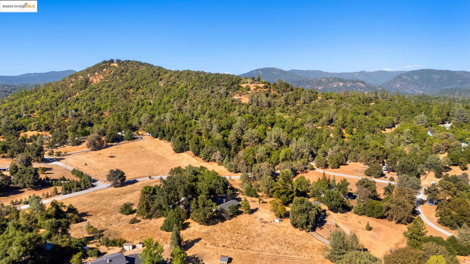 16641 Buckhorn Mountain Road Sonora, CA 95370 - Photo 42 of 44 Aerial view of a mountain backdrop and a forest