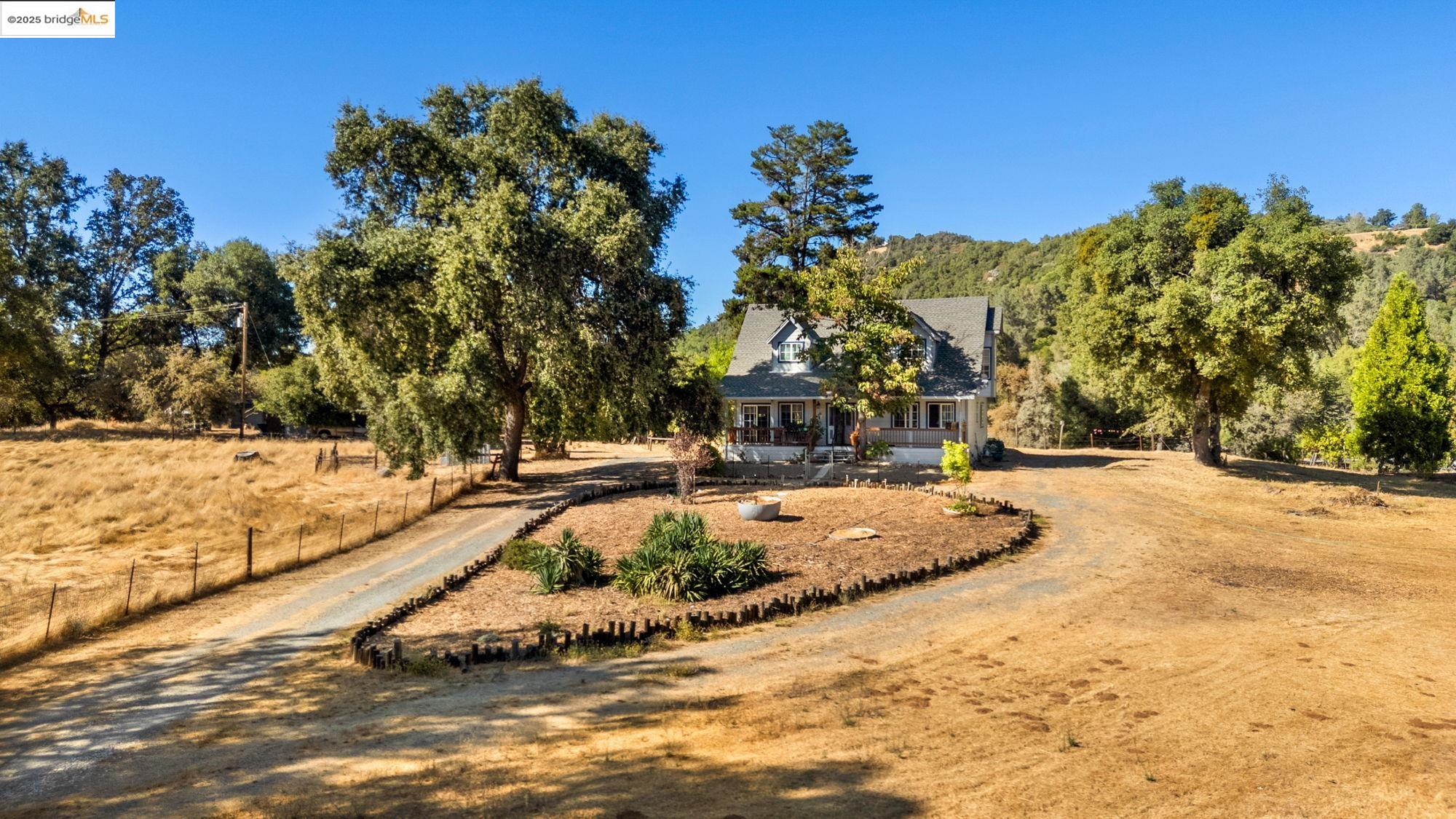16641 Buckhorn Mountain Road Sonora, CA 95370 - Photo 44 of 44 View of front of home featuring dirt driveway, covered porch, and a view of rural / pastoral area
