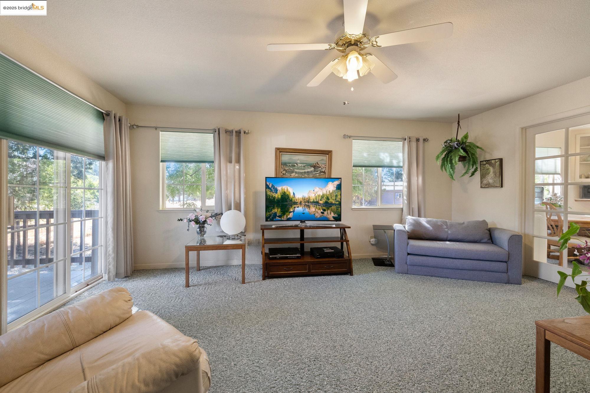 16641 Buckhorn Mountain Road Sonora, CA 95370 - Photo 7 of 44 Carpeted living area featuring a ceiling fan and baseboards