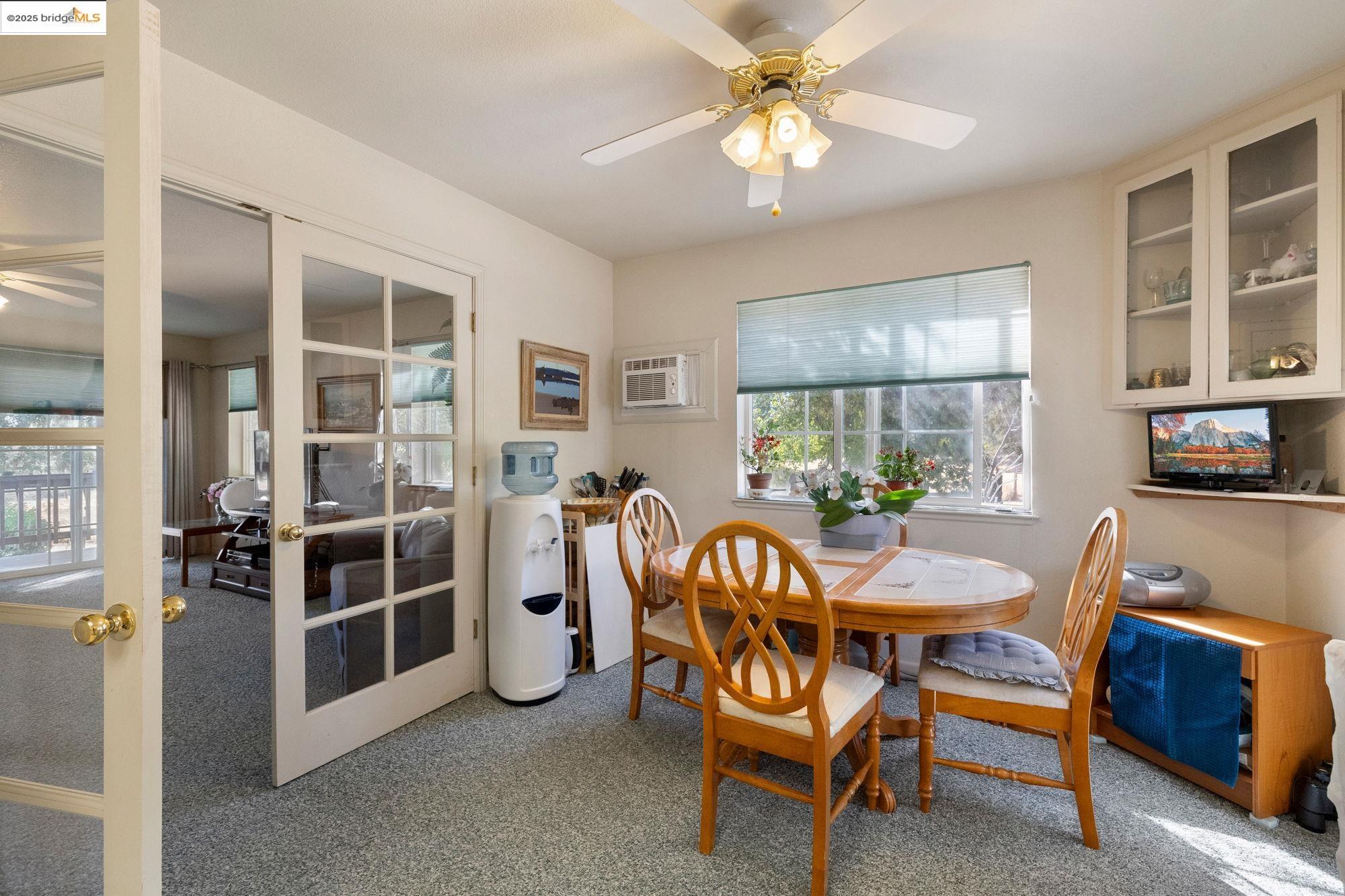 16641 Buckhorn Mountain Road Sonora, CA 95370 - Photo 9 of 44 Carpeted dining room featuring ceiling fan and an AC wall unit