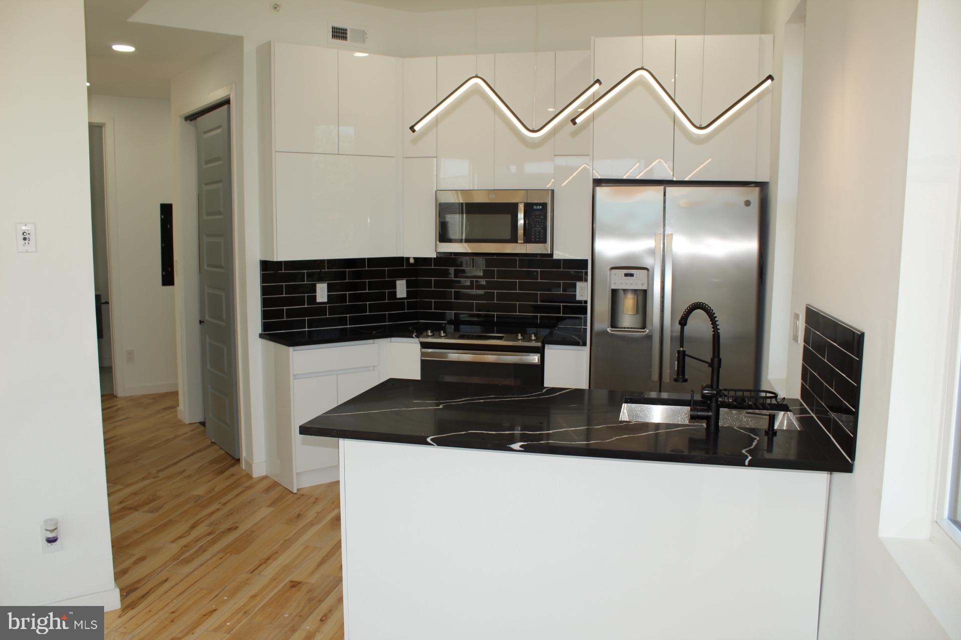 3017 Ridge Avenue, Unit B Philadelphia, PA 19121 - Photo 10 of 29 Sleek modern kitchen with stylish accents.