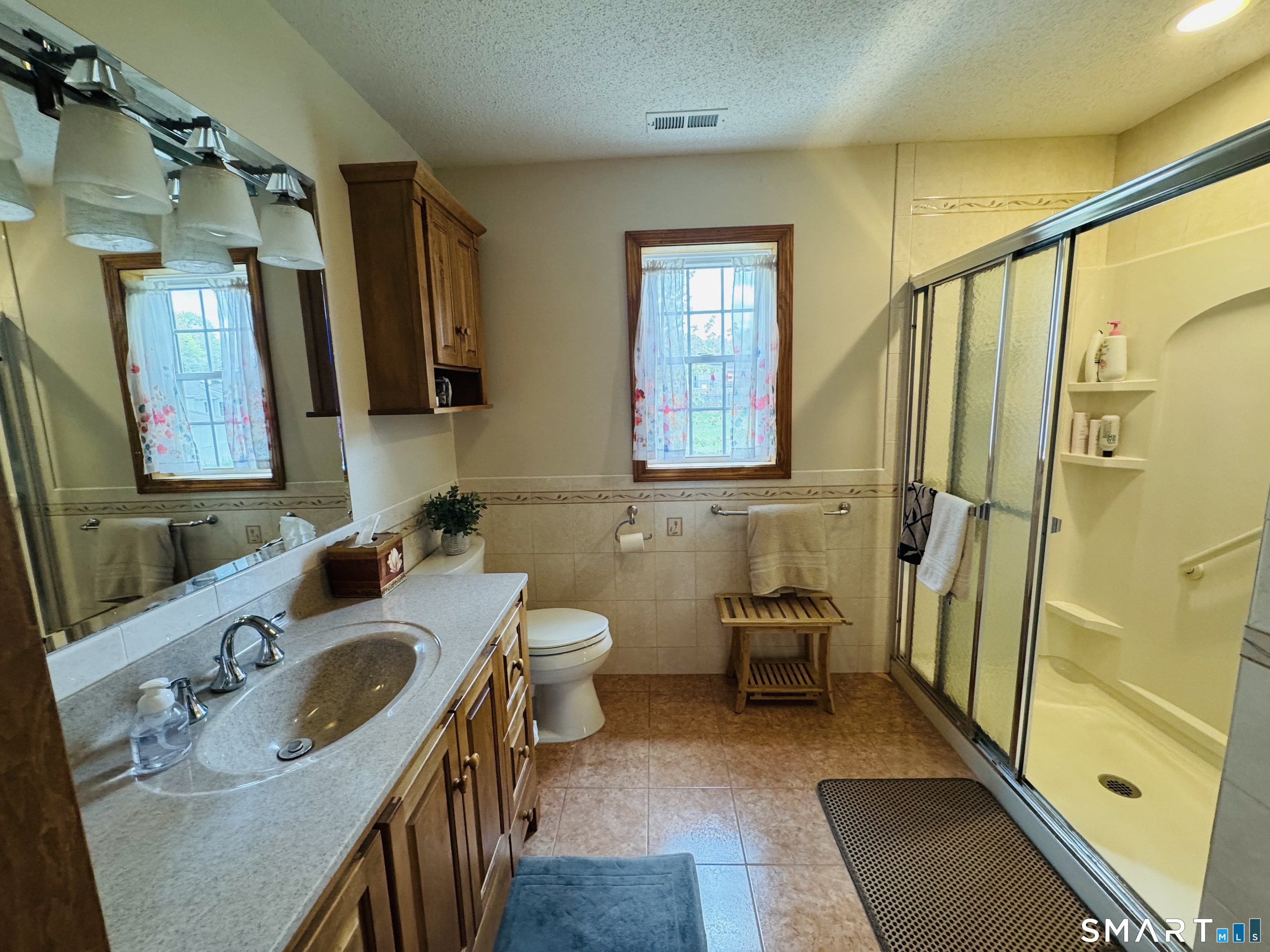 1514 Woodtick Road Wolcott, CT 06716 - Photo 23 of 23 a bathroom with a sink a toilet and mirror
