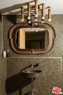 a bathroom with a sink and mirror